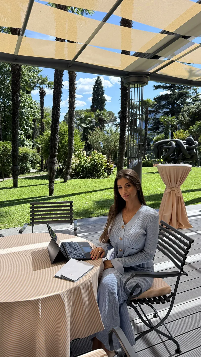 Angelica working with a laptop outdoors