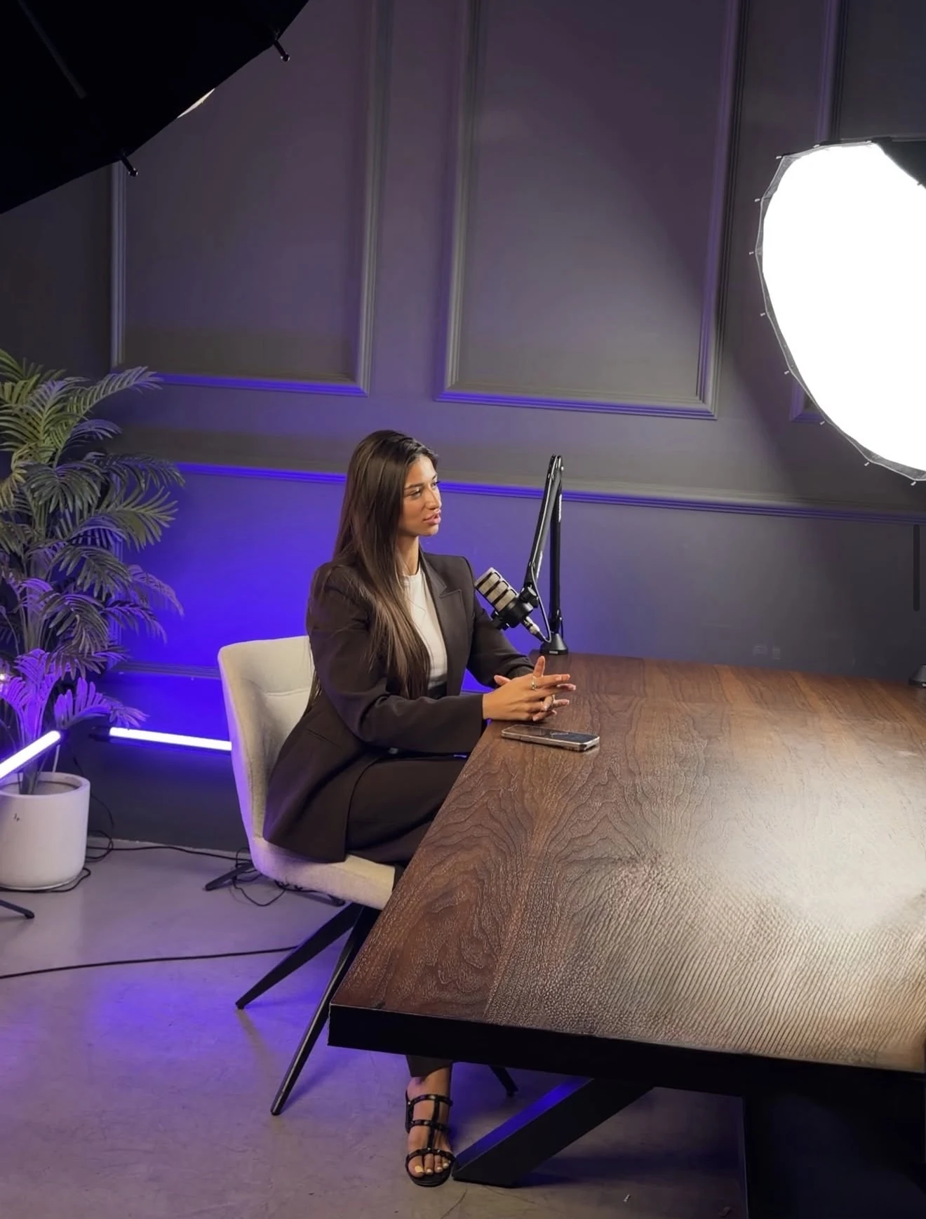 Angelica at a podcast microphone